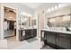 Beautiful bathroom featuring double sinks, large mirror, modern lighting and a walk in closet at 7473 Deschutes Cir, Las Vegas, NV 89129