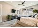 Comfortable bedroom features ceiling fan, large windows, and stylish furniture at 7473 Deschutes Cir, Las Vegas, NV 89129