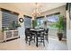 Bright dining area features modern chandelier, large windows with views, and stylish cabinet at 7473 Deschutes Cir, Las Vegas, NV 89129