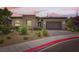 Charming single-story home featuring a stone facade and a two-car garage at 7473 Deschutes Cir, Las Vegas, NV 89129