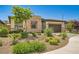Attractive single-story house with stone facade, two-car garage, and desert landscaping at 7473 Deschutes Cir, Las Vegas, NV 89129