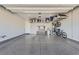 Spacious garage with epoxy flooring, overhead storage racks, and room for multiple bikes at 7473 Deschutes Cir, Las Vegas, NV 89129