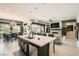 Open-concept kitchen featuring an island with seating, stainless appliances, and seamless access to living areas at 7473 Deschutes Cir, Las Vegas, NV 89129