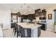 Modern kitchen with an island, stainless steel appliances, and dark cabinets at 7473 Deschutes Cir, Las Vegas, NV 89129