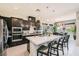 Modern kitchen with an island, stainless steel appliances, and dark cabinets at 7473 Deschutes Cir, Las Vegas, NV 89129