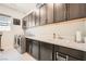 Well-equipped laundry room with ample counter space, storage cabinets, and modern washer and dryer at 7473 Deschutes Cir, Las Vegas, NV 89129