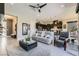 Bright and airy living space with gray tile floors, a comfortable sofa, and modern furnishings at 7473 Deschutes Cir, Las Vegas, NV 89129
