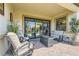 Relaxing outdoor patio featuring comfortable lounge seating, a sleek fire pit, and views of the landscaped backyard at 7473 Deschutes Cir, Las Vegas, NV 89129