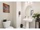 Stylish powder room featuring a pedestal sink, modern fixtures, and elegant decor at 7473 Deschutes Cir, Las Vegas, NV 89129