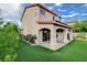 Backyard showing a covered patio, well-maintained artificial turf, and manicured landscaping at 7709 Sierra Paseo Ln, Las Vegas, NV 89128