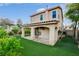 Outdoor living space featuring an open patio, artificial turf, and mature landscaping at 7709 Sierra Paseo Ln, Las Vegas, NV 89128