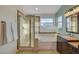 The bathroom boasts a tub, glass shower and modern fixtures at 7709 Sierra Paseo Ln, Las Vegas, NV 89128