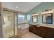 Bright bathroom with a glass shower, soaking tub, double sink vanity, and tiled floors at 7709 Sierra Paseo Ln, Las Vegas, NV 89128