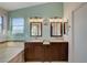 This bathroom is equipped with double vanities and a tub at 7709 Sierra Paseo Ln, Las Vegas, NV 89128