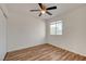 Bright bedroom with wood floors, ceiling fan and a window at 7709 Sierra Paseo Ln, Las Vegas, NV 89128
