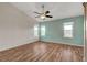 This primary bedroom offers a ceiling fan and three windows at 7709 Sierra Paseo Ln, Las Vegas, NV 89128