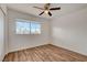 Sun-filled bedroom featuring wood floors, ceiling fan and window at 7709 Sierra Paseo Ln, Las Vegas, NV 89128