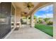 Covered patio with ceiling fans that overlooks artificial turf and a landscaped garden at 7709 Sierra Paseo Ln, Las Vegas, NV 89128