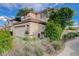 A two-story home featuring desert landscaping, a tile roof, and a two-car garage at 7709 Sierra Paseo Ln, Las Vegas, NV 89128