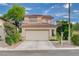 Charming two-story home featuring a red tile roof, two-car garage, and desert landscaping at 7709 Sierra Paseo Ln, Las Vegas, NV 89128