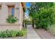 Close up of a home's exterior featuring a garden path and desert landscaping at 7709 Sierra Paseo Ln, Las Vegas, NV 89128