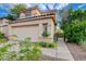 View of a two-story home featuring a two-car garage and desert landscaping at 7709 Sierra Paseo Ln, Las Vegas, NV 89128