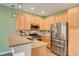 Well-equipped kitchen featuring stainless steel appliances, wood cabinets, and granite countertops at 7709 Sierra Paseo Ln, Las Vegas, NV 89128
