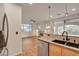 Open-concept kitchen view showcasing stainless steel appliances and granite countertops in a well-lit space at 7709 Sierra Paseo Ln, Las Vegas, NV 89128