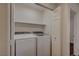 Handy laundry room with modern washer and dryer at 7709 Sierra Paseo Ln, Las Vegas, NV 89128