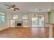 Living room area featuring wood flooring, a fireplace, and backyard access at 7709 Sierra Paseo Ln, Las Vegas, NV 89128