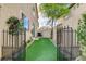 Enclosed side yard featuring artificial turf, privacy fencing, and low-maintenance landscaping at 7709 Sierra Paseo Ln, Las Vegas, NV 89128