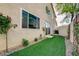 Narrow side yard boasts low-maintenance landscaping, artificial turf, and privacy fencing at 7709 Sierra Paseo Ln, Las Vegas, NV 89128