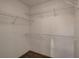 Walk-in closet with white wire shelving and neutral carpeting at 7709 Sierra Paseo Ln, Las Vegas, NV 89128