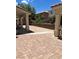 Large backyard patio featuring brick pavers and view of the home's exterior at 7851 Tidal Pool Ct, Las Vegas, NV 89139