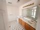Bright bathroom featuring a double sink vanity and black and white tiled flooring at 7851 Tidal Pool Ct, Las Vegas, NV 89139
