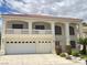 Stunning two-story home featuring a balcony, arched windows, and a three-car garage at 7851 Tidal Pool Ct, Las Vegas, NV 89139