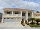 Charming two-story home featuring a three-car garage, balcony, and well-manicured landscaping at 7851 Tidal Pool Ct, Las Vegas, NV 89139