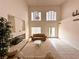 Bright, high-ceiling living room with fireplace, chandelier, and large windows at 7851 Tidal Pool Ct, Las Vegas, NV 89139