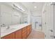 Bathroom with double sink vanity and large mirror, plus glass shower at 7908 House Sparrow St, North Las Vegas, NV 89084