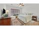 Bright bedroom with light-colored bedding, ceiling fan, and window at 7908 House Sparrow St, North Las Vegas, NV 89084
