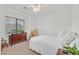 Bedroom with a ceiling fan, large window, dresser, and area rug at 7908 House Sparrow St, North Las Vegas, NV 89084