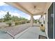 Covered patio with ceiling fan overlooking well-maintained desert landscaping at 7908 House Sparrow St, North Las Vegas, NV 89084
