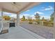Covered patio with ceiling fan overlooking desert landscaping and community at 7908 House Sparrow St, North Las Vegas, NV 89084