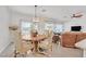 Cozy dining room featuring hardwood floors and views into backyard at 7908 House Sparrow St, North Las Vegas, NV 89084