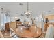 Bright dining area with view to the kitchen, living room and stainless-steel appliances at 7908 House Sparrow St, North Las Vegas, NV 89084