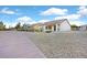 Exterior view of home with desert landscaping and walkway on a bright, sunny day at 7908 House Sparrow St, North Las Vegas, NV 89084