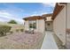 Inviting front porch with tiled patio, a cozy bench, and meticulously xeriscaped yard at 7908 House Sparrow St, North Las Vegas, NV 89084
