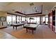 Spacious game room with two pool tables, large windows, and comfortable seating areas at 7908 House Sparrow St, North Las Vegas, NV 89084