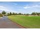 View of community golf course along paved pathway on a sunny day at 7908 House Sparrow St, North Las Vegas, NV 89084