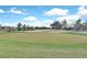 View of well maintained community golf course green with trees and homes in the background at 7908 House Sparrow St, North Las Vegas, NV 89084